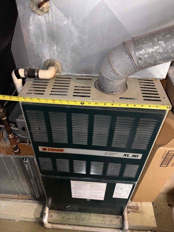 Completed inspection of existing Trane XL 80 furnace and electrical panel for replacement estimate. Took measurements of current unit and documented electrical service configuration to determine appropriate sizing and compatibility requirements for new system installation.