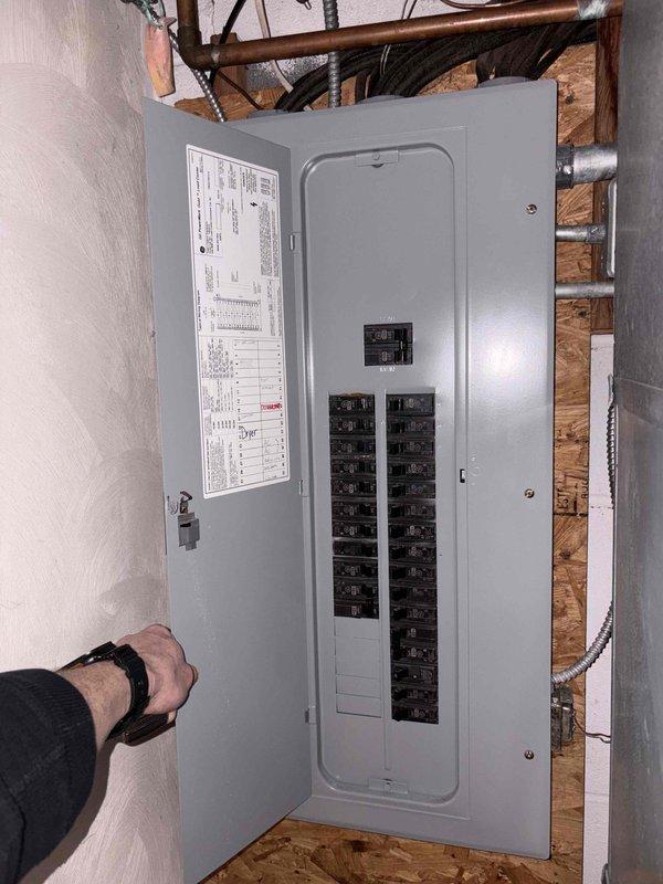 Completed inspection of existing Trane XL 80 furnace and electrical panel for replacement estimate. Took measurements of current unit and documented electrical service configuration to determine appropriate sizing and compatibility requirements for new system installation.