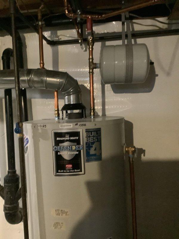 Successfully completed a comprehensive flush of the Bradford White "Defender" tanked water heater system to remove sediment and restore optimal performance. Inspected all connected components including copper pipes, expansion tank, valves, and fittings to ensure proper operation and no leaks. Customer arrived later than scheduled appointment time and was informed about additional requested services (bathroom faucet cartridge installation and downstairs toilet replacement estimate).