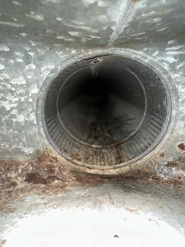 Performed comprehensive duct cleaning service on HVAC system, addressing significant rust and corrosion observed at duct connections. Inspection revealed aging ductwork with visible damage including a crack at one pipe opening, which was documented with detailed photos for service records.