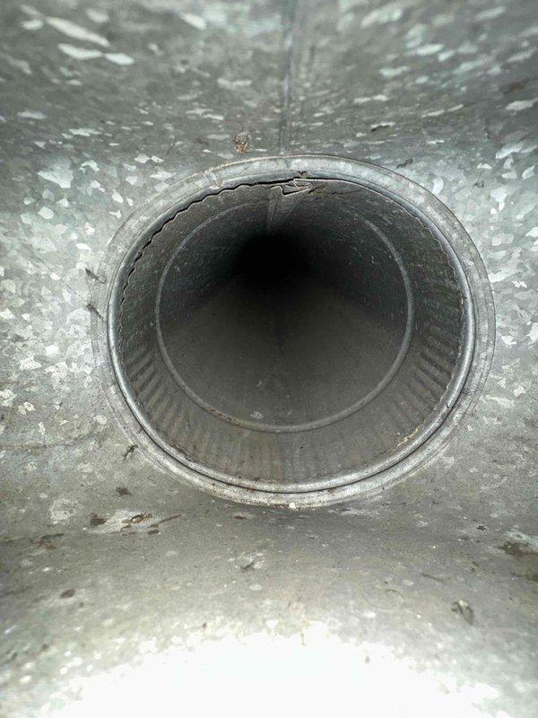 Performed comprehensive duct cleaning service on HVAC system, addressing significant rust and corrosion observed at duct connections. Inspection revealed aging ductwork with visible damage including a crack at one pipe opening, which was documented with detailed photos for service records.