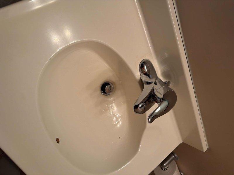 Successfully installed new lavatory faucet with complete drain assembly and P-trap replacement. Corrected previous moisture issues by ensuring proper sealing at all connection points with new fixtures. System now functions properly with no leaks observed during final testing.