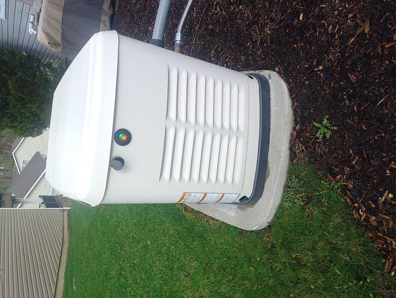 Responded to service call for generator with activated yellow indicator light. Upon inspection, found unit in good physical condition with proper installation on concrete pad. Accessed interior control panel, checked BLDC display readings, verified electrical connections, and reset system which cleared the warning light. Generator now functioning normally with no operational issues detected.
