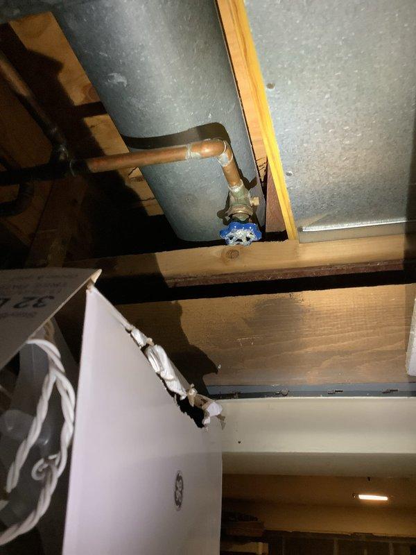 Replaced severely corroded 80-gallon electric water heater that was actively leaking from tank. Also repaired leaking outdoor spigot by replacing valve assembly and securing copper supply line connection in ceiling joist area where damaged insulation was observed.