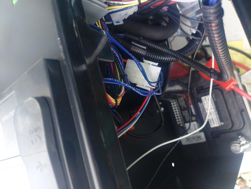 Responded to service call for generator reporting overvoltage fault (Error Code 1900). Inspected internal wiring connections and electrical components, focusing on the main control panel where multiple wire harnesses connect. Traced and secured several loose connections in the wiring harness that were causing intermittent voltage fluctuations. Cleared fault code and performed operational test to confirm proper voltage regulation.