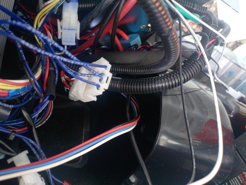 Responded to service call for generator reporting overvoltage fault (Error Code 1900). Inspected internal wiring connections and electrical components, focusing on the main control panel where multiple wire harnesses connect. Traced and secured several loose connections in the wiring harness that were causing intermittent voltage fluctuations. Cleared fault code and performed operational test to confirm proper voltage regulation.