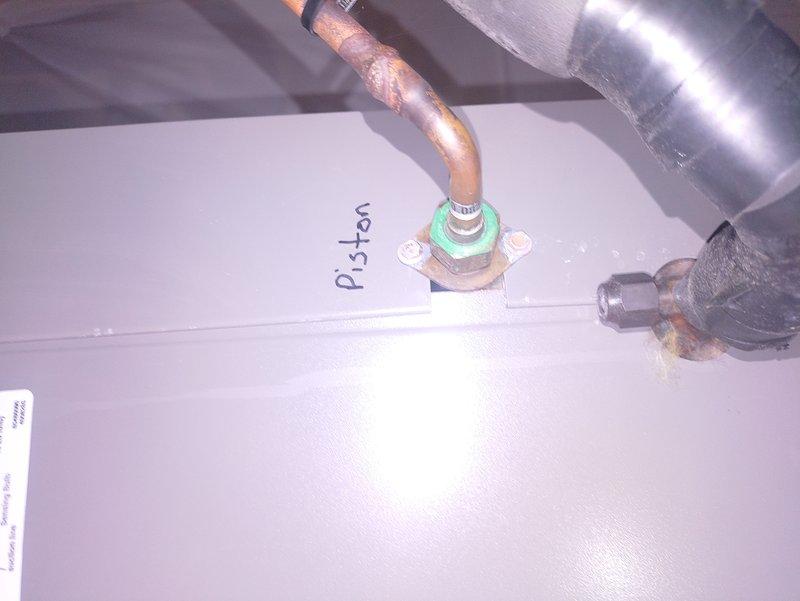Performed routine MVP cooling maintenance service. Inspected refrigerant system components, noting "Piston" metering device with visible copper line oxidation. Examined blower wheel assembly which showed minimal dust accumulation, ensuring proper airflow operation for the cooling system.