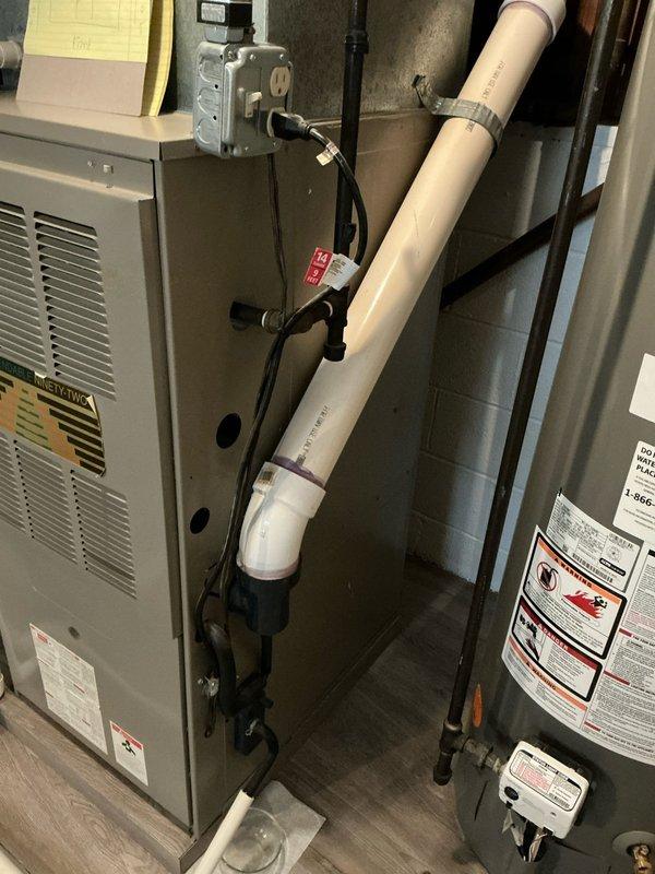 Conducted inspection of aging HVAC system including Rheem Performance water heater, furnace unit, and associated plumbing components in basement utility area. Evaluated existing installation consisting of copper/PVC piping network, electrical connections, and condensate drainage system to prepare comprehensive replacement estimate for both furnace and air conditioning units.