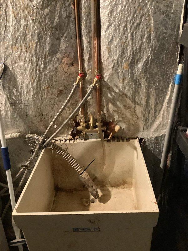 Installed new laundry faucet on basement utility sink by cutting existing copper supply lines and rebuilding with new brass hose bibs. Added dedicated laundry connections and installed ball valve for front sillcock as quoted, completing the comprehensive plumbing update to address aging fixtures and ensure proper water control.