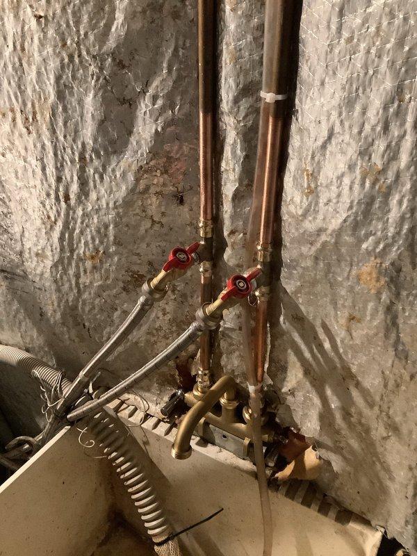 Installed new laundry faucet on basement utility sink by cutting existing copper supply lines and rebuilding with new brass hose bibs. Added dedicated laundry connections and installed ball valve for front sillcock as quoted, completing the comprehensive plumbing update to address aging fixtures and ensure proper water control.
