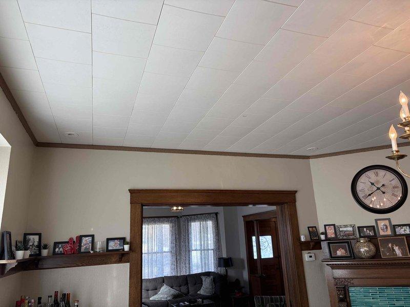 Conducted high velocity AC replacement estimate in a residential property with traditional styling. Inspection revealed existing ductwork system with insulated metal pipes wrapped in silver metallic tape and fiberglass insulation requiring assessment for compatibility with new high velocity system. Customer requires morning appointments due to professional commitments with Channel 3 news.