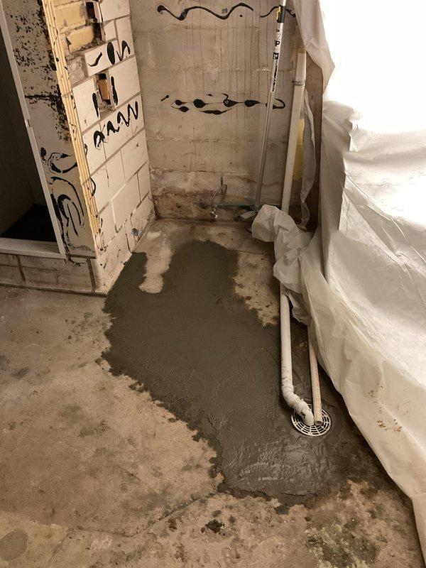 Successfully replaced floor drain under concrete slab, requiring concrete removal and patching around the new PVC drain installation. Connected new drain line to existing plumbing system, securing all components with proper mounting brackets and ensuring complete drainage functionality.