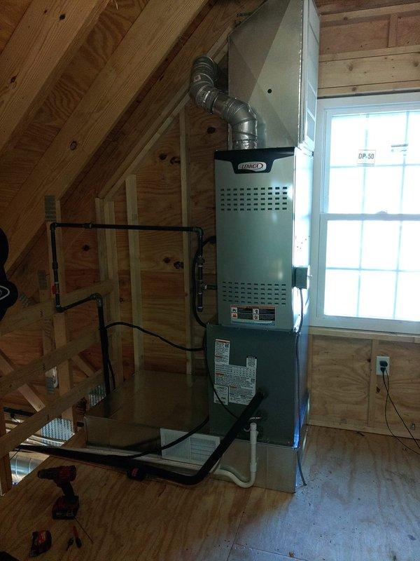 Installed new Lennox air conditioning system including attic-mounted air handler with proper ductwork connections and exterior condenser unit mounted on brackets against the house. Completed all necessary electrical connections including disconnect switch and conduit installation for a fully operational cooling system.