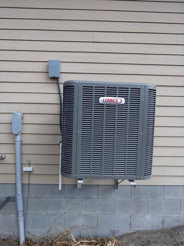 Installed new Lennox air conditioning system including attic-mounted air handler with proper ductwork connections and exterior condenser unit mounted on brackets against the house. Completed all necessary electrical connections including disconnect switch and conduit installation for a fully operational cooling system.