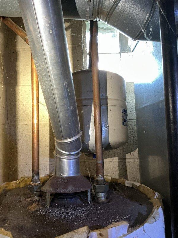 Investigated water leak in basement during scheduled service call. Inspected copper supply lines and ventilation ducting in utility area, noting minor corrosion at pipe connection points. Located source of leak at junction where copper piping interfaces with wall penetration; applied appropriate sealant to resolve the issue.