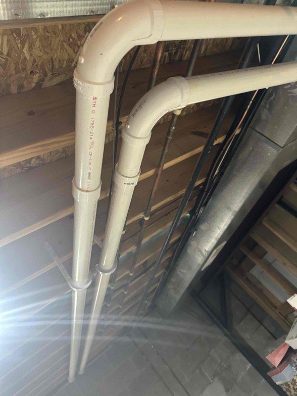Completed installation of a 90% efficiency furnace as second phase of HVAC project. Installed proper PVC venting through exterior wall with appropriate clearances and slope. Connected condensate drainage system with code-compliant PVC piping and fittings in basement area.