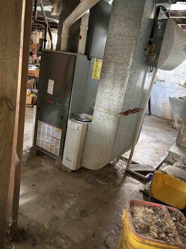Inspected 11-year-old Trane furnace with confirmed cracked heat exchanger. Documented existing installation including PVC venting, ductwork configuration, and current dimensions for proper replacement sizing. Provided replacement quote for new furnace system.