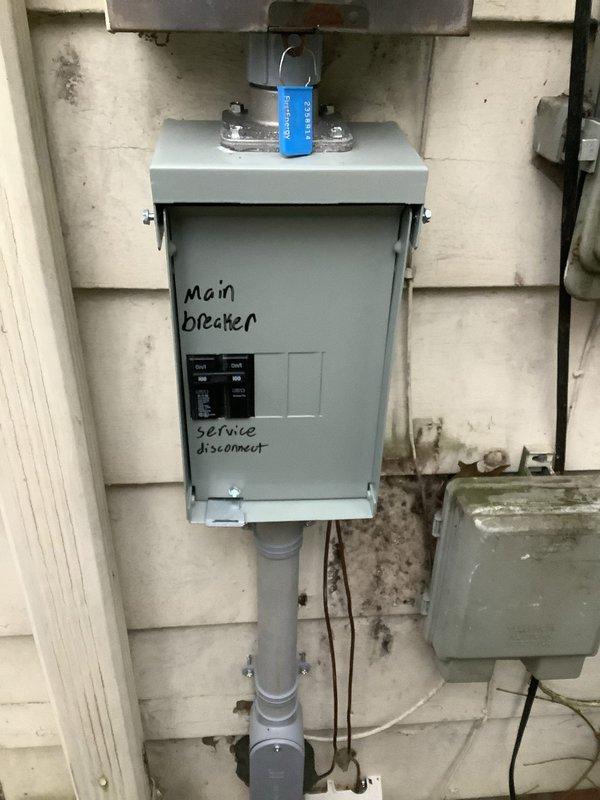 Successfully installed an emergency disconnect for electrical panel replacement as required by code. Labeled service disconnect properly, installed bonding strap to connect the GEC to the grounded service conductor, and documented the installation with photos showing the completed exterior panel mounting with proper labeling and security features.