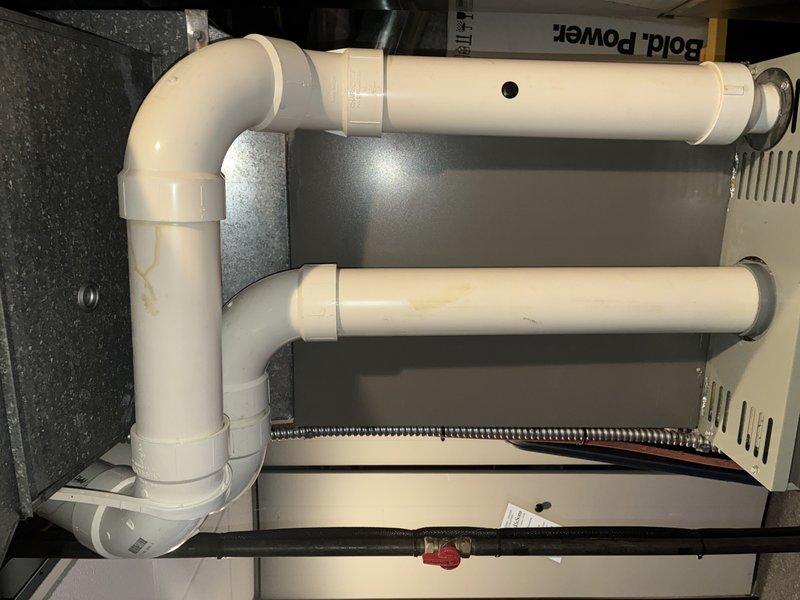 Performed scheduled furnace tune-up on residential gas furnace system. Inspected condensate drain system for proper operation and verified all PVC exhaust/intake piping connections were secure. Confirmed unit was operating with normal flame pattern and proper electrical connectivity as evidenced by functioning indicator lights.