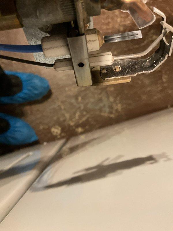 Performed tune-up service on a 24+ year old gas furnace. Inspected electrical connections and Honeywell control components, noting some age-related wear on mounting surfaces. Verified proper operation of switch assembly and wiring integrity during the maintenance procedure.