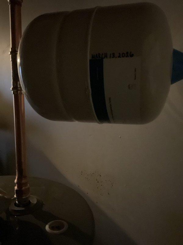 Completed installation of an expansion tank on a 4-year-old Rheem water heater to bring system up to code. Removed failing dielectric connector on the cold inlet side and installed new connections from the ball valve to appropriate tie-in point. All components were properly staged and installed according to manufacturer specifications.