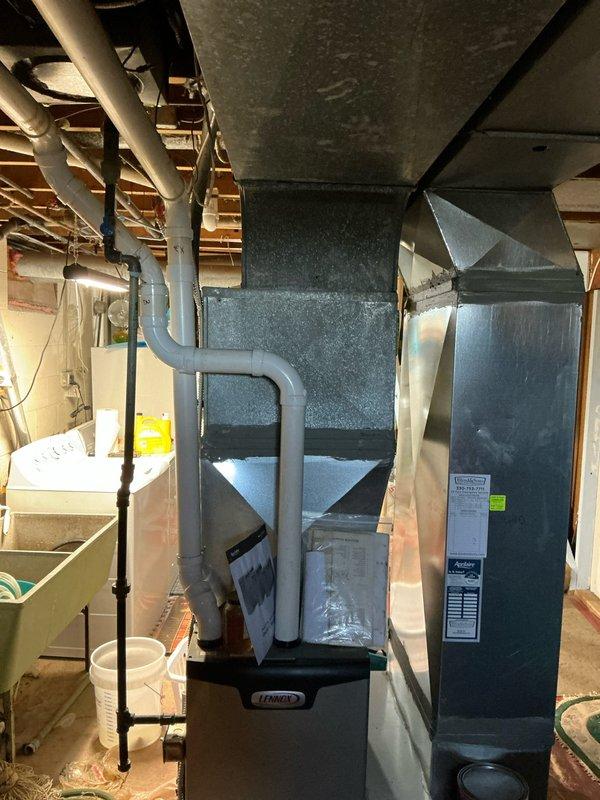 Completed site evaluation for replacement of existing Lennox furnace system. Inspected current installation in basement utility area, noting ductwork configuration, ventilation requirements, and available space constraints. Documented PVC venting pathways and existing connection points to facilitate accurate quote for complete HVAC system replacement.