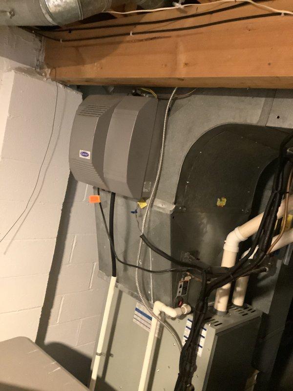 Conducted on-site evaluation of a 9-year-old furnace with confirmed cracked heat exchanger. Inspection of basement HVAC system revealed the existing furnace/air handler setup with attached humidifier requiring full replacement. Provided comprehensive replacement estimate for complete furnace and AC system with documentation of current installation configuration and structural considerations.