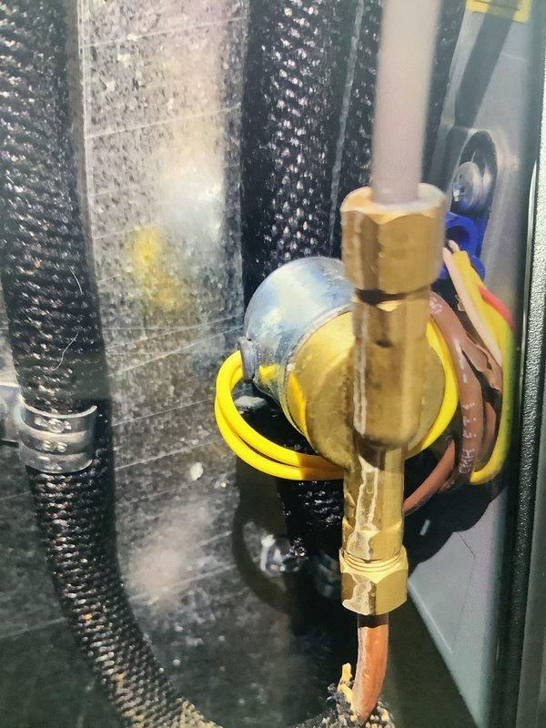 Responded to service call for water leak on year-old Aprilaire humidifier. Diagnosed issue as leaking supply tube connection at the brass valve fitting. Replaced faulty seal, secured connections, and verified proper operation with no further leakage.