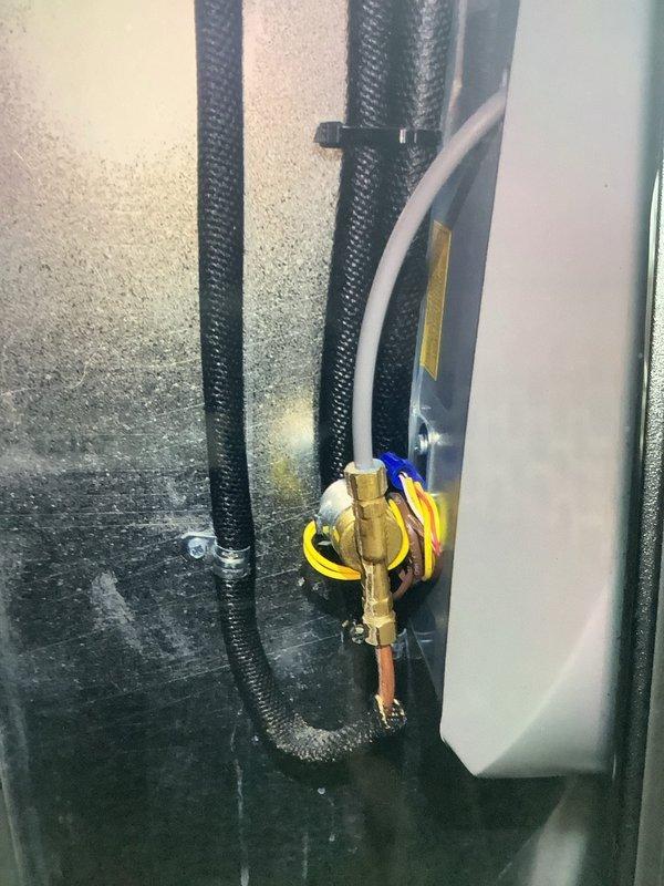 Responded to service call for water leak on year-old Aprilaire humidifier. Diagnosed issue as leaking supply tube connection at the brass valve fitting. Replaced faulty seal, secured connections, and verified proper operation with no further leakage.