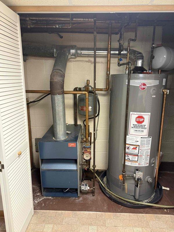 Successfully installed a high-efficiency Navien combi boiler system with three Taco zone valves, replacing the existing older blue furnace unit. System includes new copper supply lines, proper PVC venting, and an expansion tank for optimal performance. All connections were pressure tested and the system was fully commissioned with proper water flow through all zones.