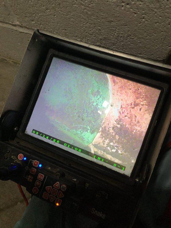 Performed camera inspection of plumbing system using electronic scope equipment. Identified corrosion and potential mineral buildup in pipes. Also noted significant deterioration and corrosion at water heater connections with evidence of previous leakage, particularly around the top fittings where copper and PVC lines connect.