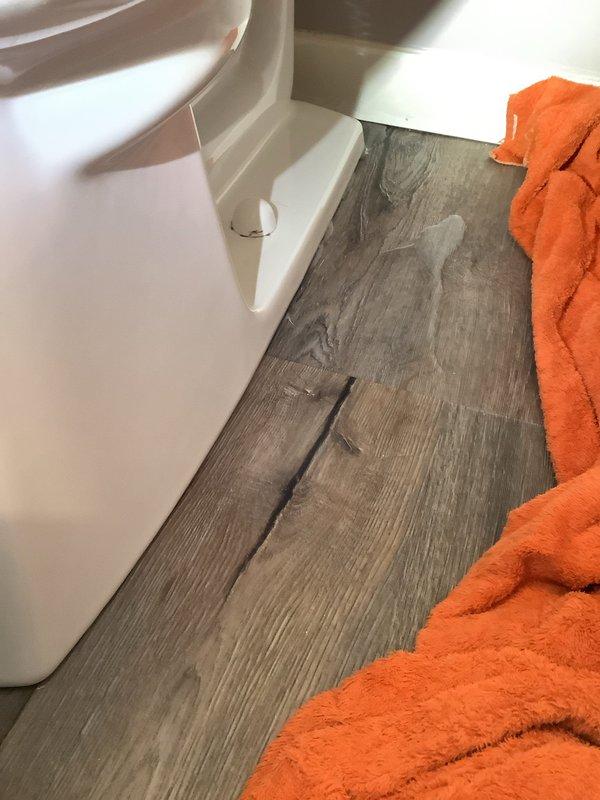 Responded to service call for toilet leaking at base. Upon inspection, discovered significant water damage to flooring and a severely corroded toilet flange. Removed toilet, assessed damage, replaced flange and wax ring, then reinstalled and sealed toilet. Verified proper operation with no leaks after repair.