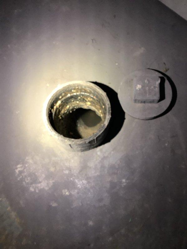 Responded to service call for a main drain backup in basement. Successfully snaked the main drain cleanout, clearing the blockage and restoring proper drainage. Documented condition of the cleanout access point and interior pipe threading which showed signs of sediment buildup and residue.