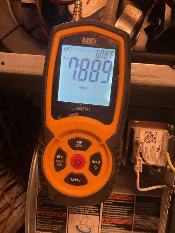 Performed annual maintenance on 3-year-old cooling system. Conducted static pressure testing with UEi EM720 meter, measuring 7.889 inH2O at 60.8°F. Verified refrigerant system operation with temperature readings of 162.5°F. System is functioning within manufacturer specifications after service.