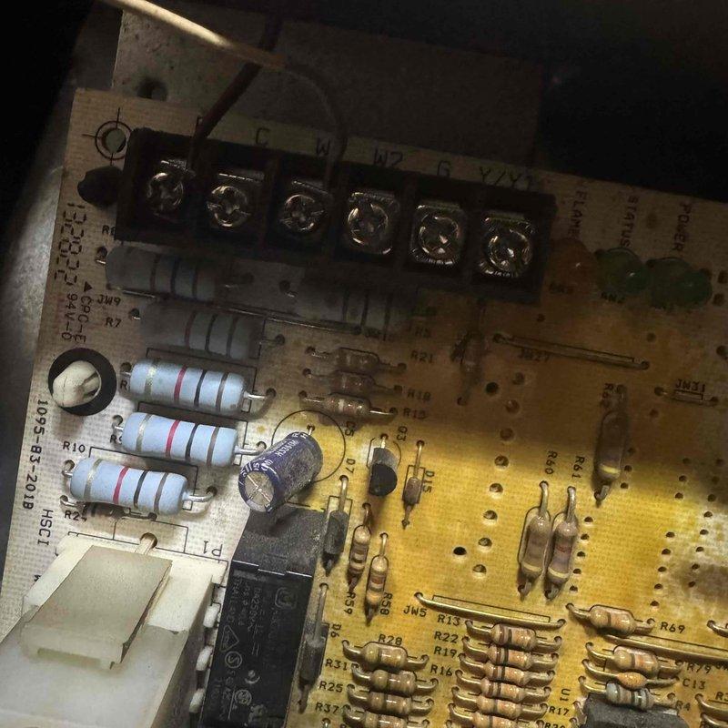 Performed scheduled furnace tune-up and inspection. Identified severe rust and corrosion on mounting bracket and mechanical components. Examined control board which showed normal operation with no visible damage to terminals, resistors, and capacitor.