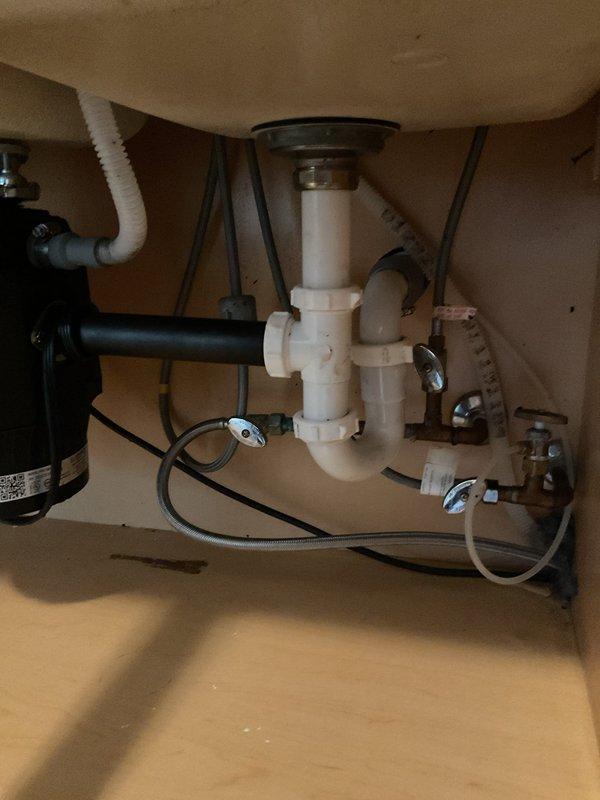 Replaced customer's malfunctioning garbage disposal with new PRO 750-6 3/4 HP quiet technology model. While system was disconnected, snaked the kitchen drain line to resolve slow drainage issue. Completed full installation with new PVC drain assembly and verified proper operation of both disposal and drain system.