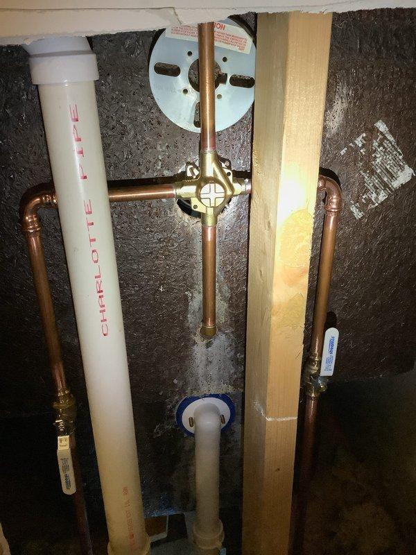 Completed replacement of waste and overflow with new lift and turn style, and installed new Moen single-handle tub/shower valve. Installation included adding shut-off valves on water lines in the access panel for improved serviceability, with all new components properly connected to existing PVC and copper supply lines.