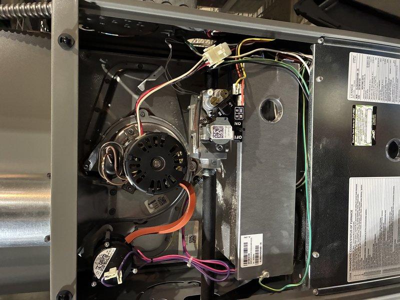 Performed a routine MVP heating service which included inspection of the blower wheel assembly and motor components. Examined the fan blades, hub connection, and shaft for proper operation and condition. Inspected the motor wiring connections (red, orange, purple, green, and white) and verified all electrical components were properly secured and functioning according to manufacturer specifications.