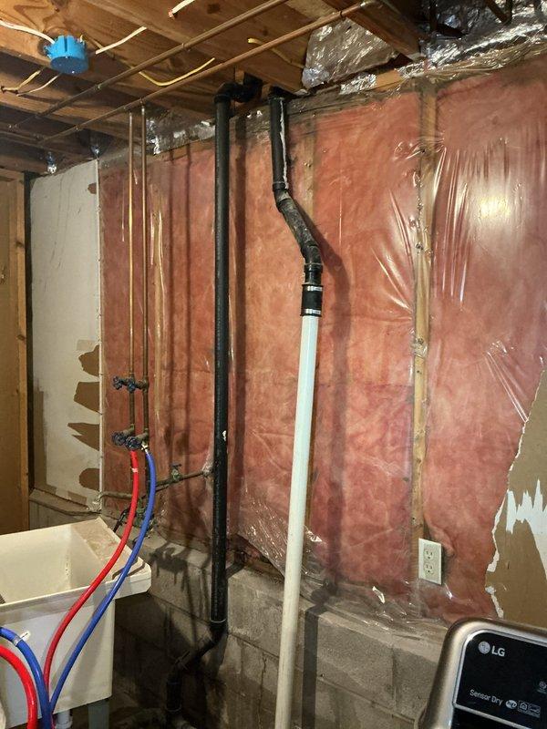 Repaired water leak in kitchen drain line where it penetrated to floor below by replacing damaged section of black PVC pipe and failed joint. Installed new properly-sealed fittings at the T-junction to eliminate ceiling leak, ensuring proper drainage from kitchen sink and dishwasher with no further water intrusion.