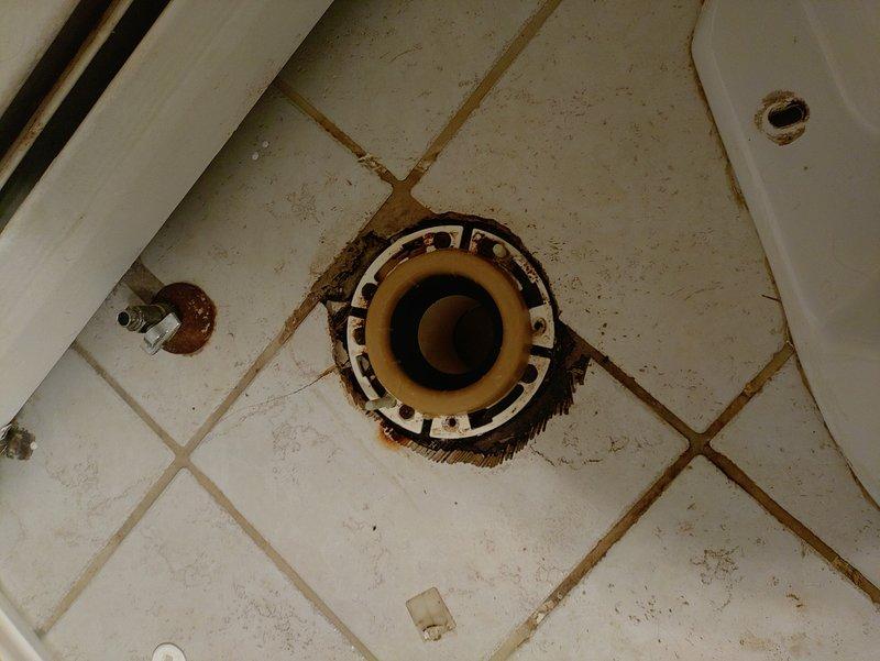 Diagnosed toilet leak issue causing water damage in basement. Inspected toilet flange and discovered deteriorated wax ring and corroded mounting hardware. Removed toilet, replaced wax ring and flange bolts, and reseated toilet with proper seal. Verified repair with test flushes confirming no further leakage to basement ceiling below.