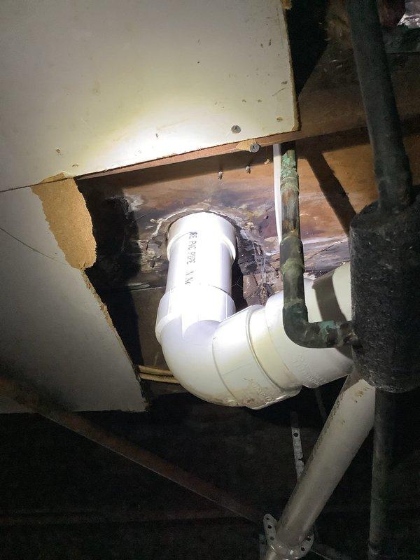 Diagnosed toilet leak issue causing water damage in basement. Inspected toilet flange and discovered deteriorated wax ring and corroded mounting hardware. Removed toilet, replaced wax ring and flange bolts, and reseated toilet with proper seal. Verified repair with test flushes confirming no further leakage to basement ceiling below.