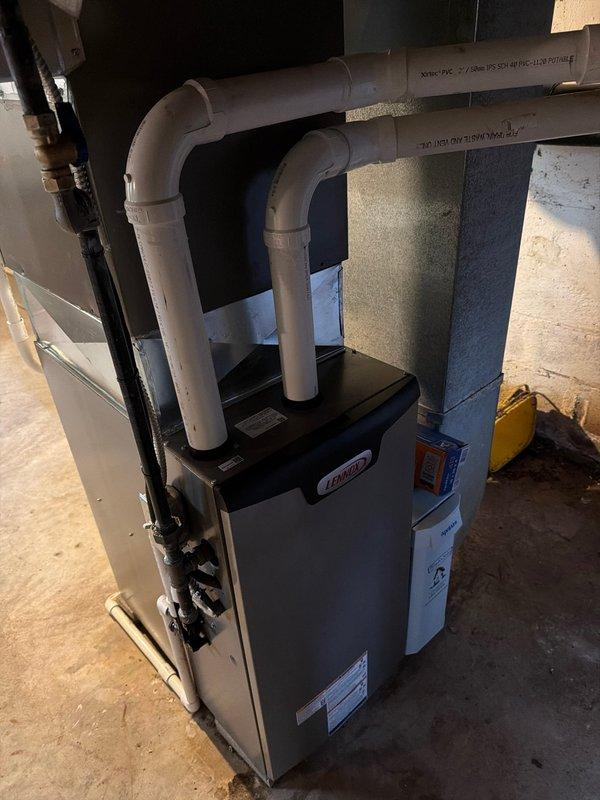 Successfully installed a 90% efficient furnace in the basement utility area, including proper venting with PVC exhaust pipes and all necessary plumbing connections. Completed installation with all components secured against the concrete wall, ensuring optimal system performance and compliance with manufacturer specifications.