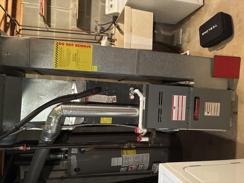 Performed routine MVP furnace maintenance service. Inspected residential HVAC system including furnace unit, ductwork connections, and thermostat functionality. Documented system condition with photos showing the properly installed furnace with attached ductwork, warning labels, and the Fieldwire thermostat control unit.