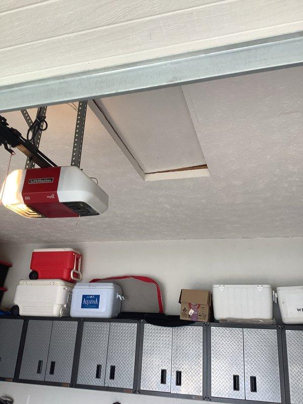 Conducted a site assessment for EV charging station installation in residential garage. Evaluated electrical panel capacity, garage layout, and potential mounting locations near vehicle parking position. Documented existing infrastructure including ceiling-mounted garage door opener system and wall storage configurations to determine optimal routing for new dedicated circuit.