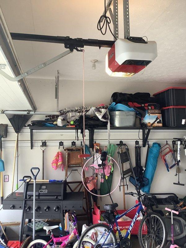 Conducted a site assessment for EV charging station installation in residential garage. Evaluated electrical panel capacity, garage layout, and potential mounting locations near vehicle parking position. Documented existing infrastructure including ceiling-mounted garage door opener system and wall storage configurations to determine optimal routing for new dedicated circuit.