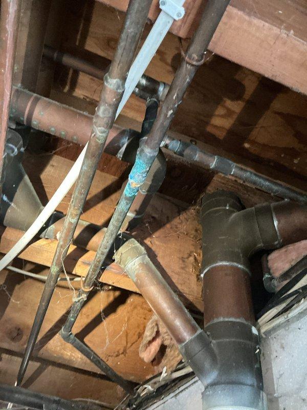 Responded to water leak service call in residential property. Upon inspection of the crawlspace, identified copper pipe corrosion with visible oxidation at multiple connection points. Repaired deteriorated soldered joints, replacing affected sections with new copper piping and ensuring proper sealing at all connection points to prevent future leakage.
