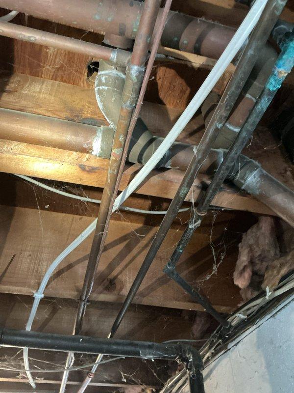 Responded to water leak service call in residential property. Upon inspection of the crawlspace, identified copper pipe corrosion with visible oxidation at multiple connection points. Repaired deteriorated soldered joints, replacing affected sections with new copper piping and ensuring proper sealing at all connection points to prevent future leakage.