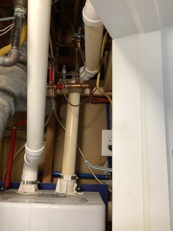 Performed scheduled maintenance on Navien tankless water heater, completing a comprehensive flush and fill service to remove mineral buildup and ensure optimal system performance. Inspected all connecting plumbing infrastructure including PVC pipes, copper lines with brass fittings, and hot/cold water lines, confirming proper operation of the unit following service completion.