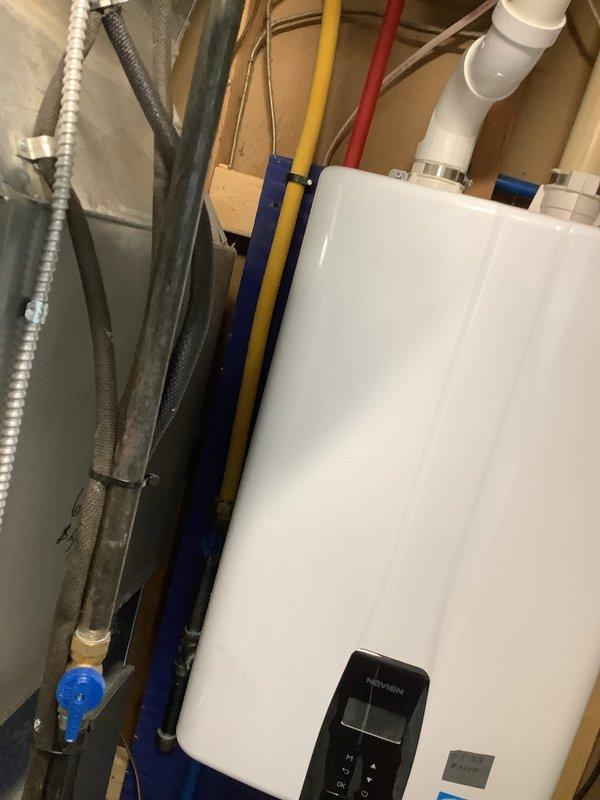 Performed scheduled maintenance on Navien tankless water heater, completing a comprehensive flush and fill service to remove mineral buildup and ensure optimal system performance. Inspected all connecting plumbing infrastructure including PVC pipes, copper lines with brass fittings, and hot/cold water lines, confirming proper operation of the unit following service completion.
