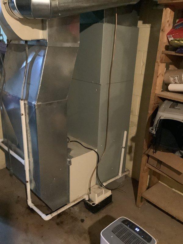 Conducted an estimate for replacement of a 21-year-old furnace and AC system in a residential basement. Inspected the existing HVAC unit, ductwork configuration, and electrical panel to assess compatibility requirements for the new installation. Documented the current system setup including sheet metal connections, drainage components, and available utility access points for proper replacement planning.